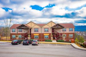 a large building with cars parked in a parking lot at The Lodges of the Great Smoky Mountains by Capital Vacations in Pigeon Forge