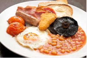 a plate of breakfast food with eggs beans and toast at Hillview Cottage in Stirling