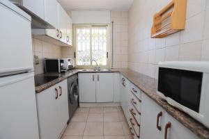 a small kitchen with a sink and a microwave at DIFFERENTFLATS Decathlon in Salou