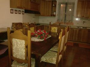 a kitchen with a wooden table with flowers on it at Villa L'Oliveto in Trevi