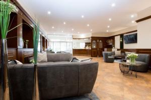 a living room with a couch and a table at Korbstadthotel Krone in Lichtenfels