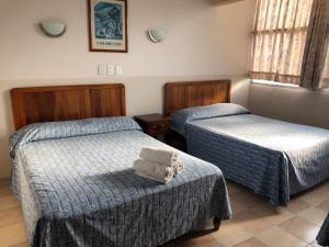 Postel nebo postele na pokoji v ubytování Hotel El Faro Malecon