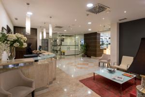a lobby with a woman sitting at a desk at Itaca Salamanca by Soho Boutique in Salamanca +27 photos
