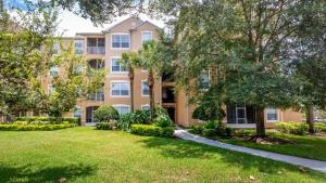 a large apartment building with trees in front of it at Disney at your doorstep in Orlando