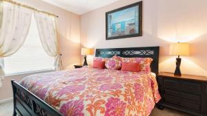 a bedroom with a bed and two lamps and a window at Disney at your doorstep in Orlando