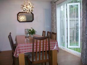 a dining room with a table and a chandelier at Number 8 in Bury Saint Edmunds