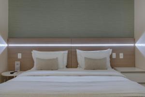 Postel nebo postele na pokoji v ubytování Hotel Adrianópolis All Suites