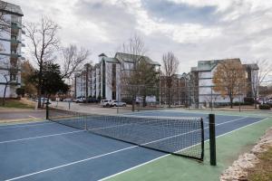 a tennis net on a tennis court in front of buildings at Carriage Place by Capital Vacations in Branson