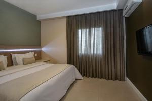 Postel nebo postele na pokoji v ubytování Hotel Adrianópolis All Suites