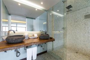 
a bathroom with a sink and a large mirror at The Charlee Hotel in Medellín
