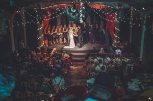 a bride and groom on the stage at a wedding at Inn at the L C Ranch in Gila