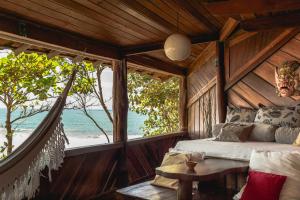 una camera con letto e vista sull'oceano di Pousada Sage Point a Itacaré