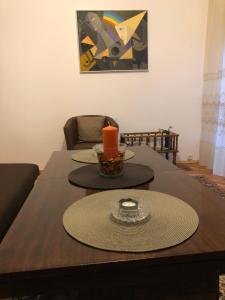 a dining room table with a candle on top of it at Practico, cómodo y céntrico. in Gabrovo