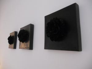 three pieces of art on a white wall at Arco' B&B Trani Cattedrale in Trani