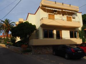 a house with a car parked in front of it at HOTEL STOUPA in Stoupa