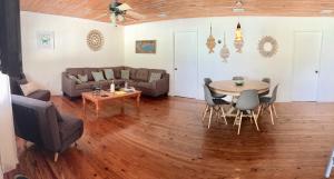 a living room with a table and a couch at Bimini Seaside Villas - Pink Cottage with Beach View in Alice Town