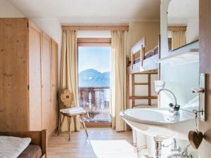 a bathroom with a sink and a large window at Rifugio Graziani Hütte in San Vigilio Di Marebbe