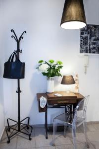 a desk with a lamp and a table with a chair at Best located executive apartment in Maroussi. in Athens