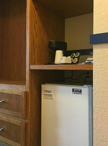 
a kitchen with a refrigerator and a microwave at The Bulldog Hotel in Silver Star
