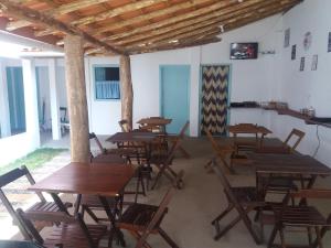 a group of tables and chairs in a room at Pousada Vila Mar in Itaúnas
