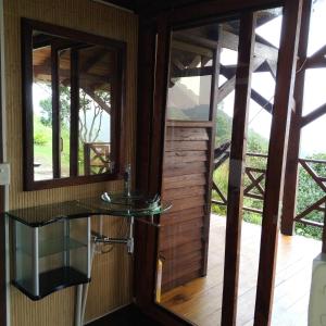 a bathroom with a glass counter and two windows at Duck House Sasaima in Sasaima