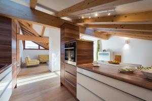 a kitchen with wooden walls and wooden counters at Alpinloft Tirol in Bad Häring