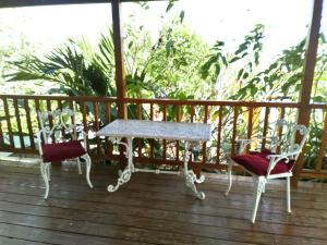 two chairs and a table on a deck at The Pool House in Saint Philip
