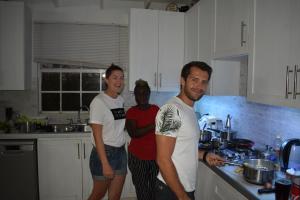 three men are standing in a kitchen at The Pool House in Saint Philip