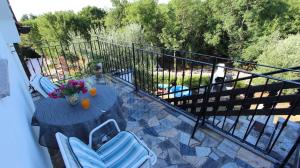 a balcony with a table and chairs on a patio at Apartment in Marsici/Insel Krk 13109 in Sveti Vid-Miholjice