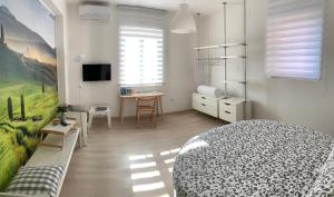 a bedroom with a bed and a desk and a table at Casa Francesco in Bolsena