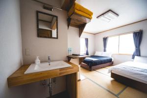 Postel nebo postele na pokoji v ubytování Hakuba Cortina Lodge