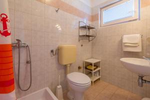 a bathroom with a toilet and a sink and a shower at Two-Bedroom Apartment in Crikvenica XXXIII in Dramalj