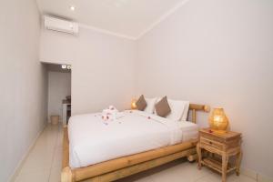 Voodi või voodid majutusasutuse Parthi Puri Ubud toas