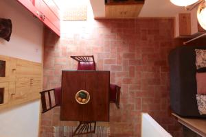 a room with a brick wall with a toilet in it at Casa das Minas in Mina de São Domingos