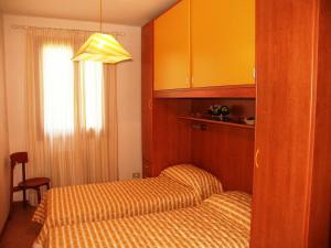 a hotel room with two beds and a window at Le Briccole in Cavallino-Treporti