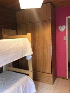 a bedroom with a bed and a cabinet with a heart on the wall at Casa Las Chulas in Ostende