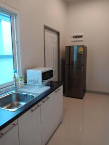 A kitchen or kitchenette at 4U Pool Villa