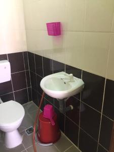 a bathroom with a sink and a toilet at Santai Lots Cherating in Kuantan