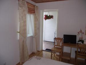a bedroom with a desk and a door with a window at Helene Villa in Kuressaare