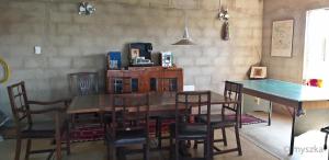 a dining room with a wooden table and chairs at Wonderland in Winterton