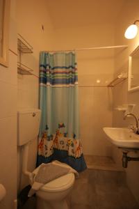 a bathroom with a toilet and a sink at Jasmine in Parikia