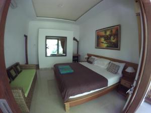 a bedroom with a large bed in a room at Rumah Made in Amed