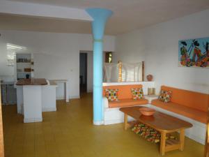 a living room with a couch and a table at A Keurmaya in Saly Portudal