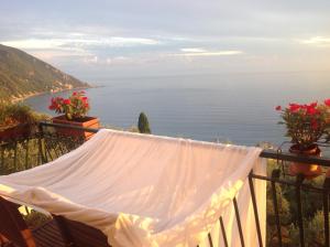 uma rede de descanso numa varanda com vista para o oceano em B&B Case Rosse em Camogli