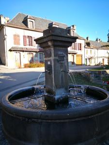 a water fountain in the middle of a street at La Ruche Cantalienne in Saint-Étienne-de-Chomeil