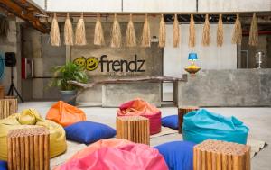 a room with a group of colored chairs and a stage at Frendz Hostel El Nido in El Nido