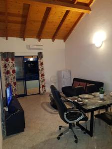 a living room with a table and chairs and a couch at SANTA MARIA Cape Verde in Santa Maria