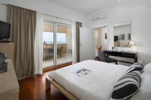 a bedroom with a bed and a desk and a window at Villa Pag in Mandre