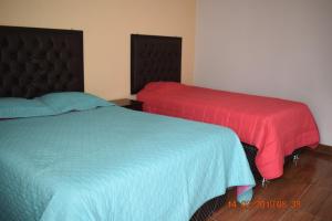 Ένα ή περισσότερα κρεβάτια σε δωμάτιο στο Arum Qurpawasi Hospedaje