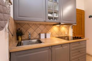 a kitchen with a sink and wooden counter top at Pansion Tina in Šilo